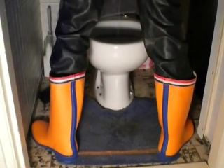 Lick nlboots - orange rubber boots and rubber trousers and toilet Tied